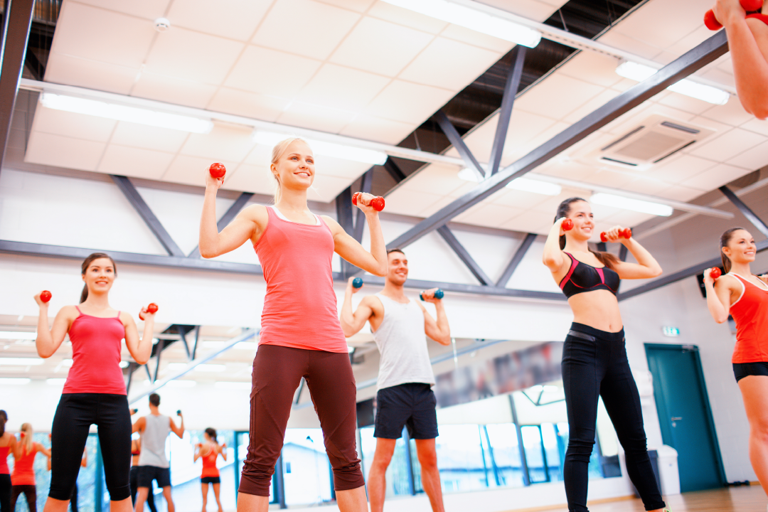 People holding hand weights in a private group training session